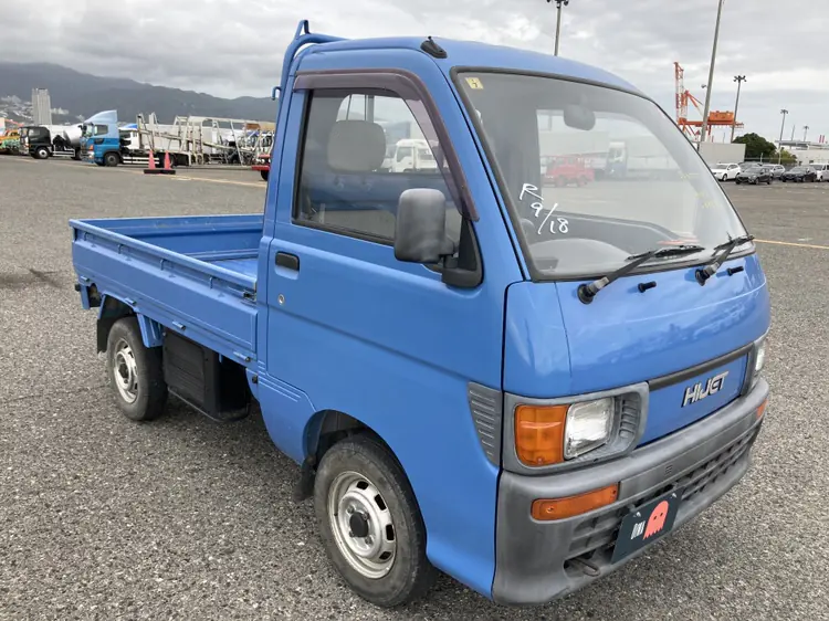 Blue Daihatsu Hijet Climber 4WD Kei Truck photographed at a Japanese vehicle port