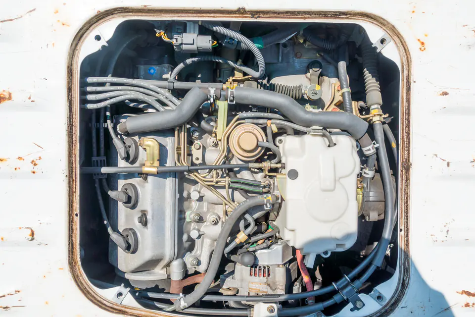 Honda Acty midship engine seen through the access hatch in the bed floor