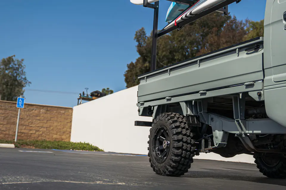 Lifted Suzuki Carry Kei Truck on off-road tires and black wheels