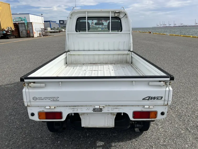Rear view of a white Suzuki Carry Kei Truck with the 4WD tailgate badge